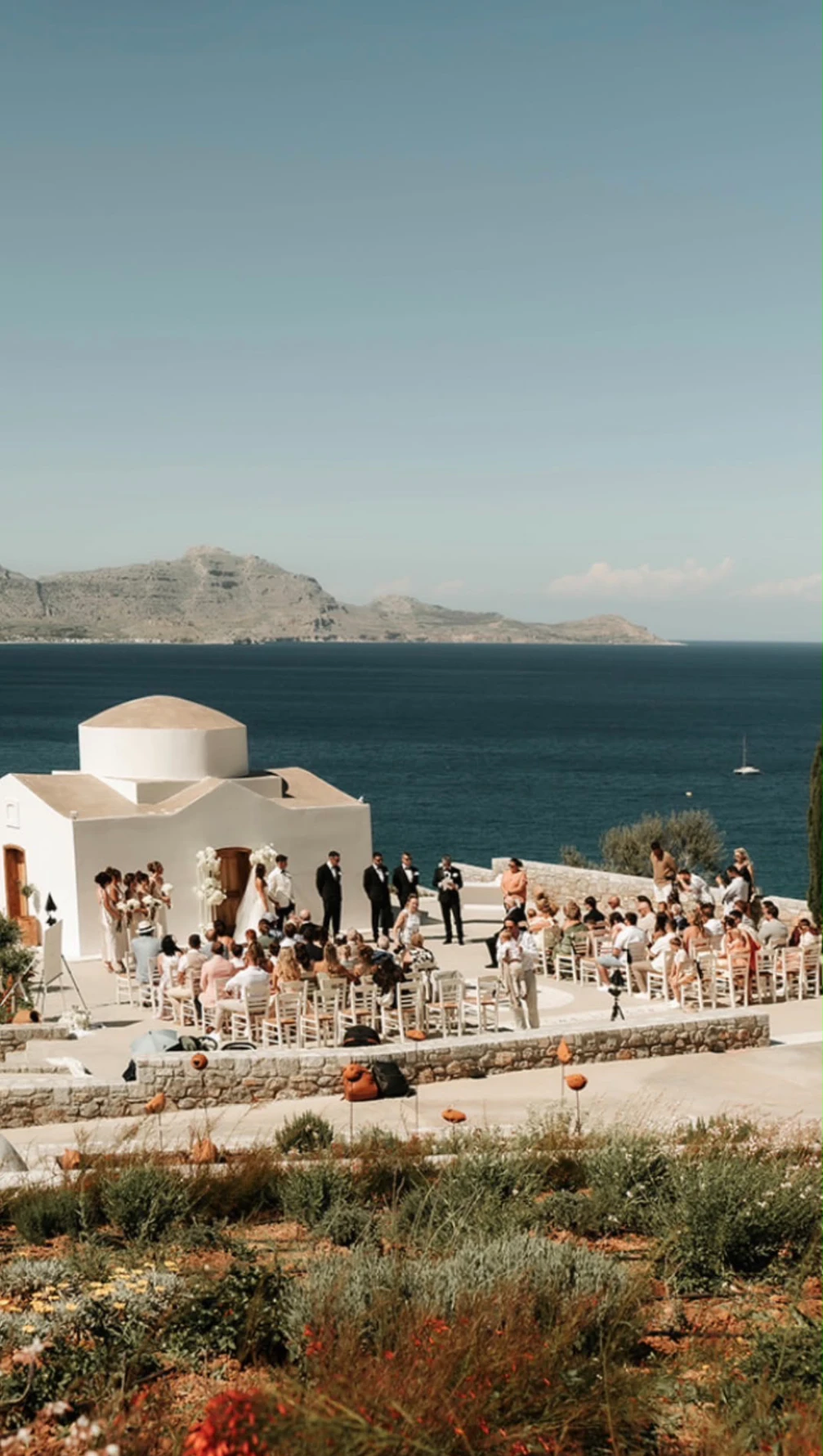 Cliffside wedding ceremony overlooking the sea on a Greek island